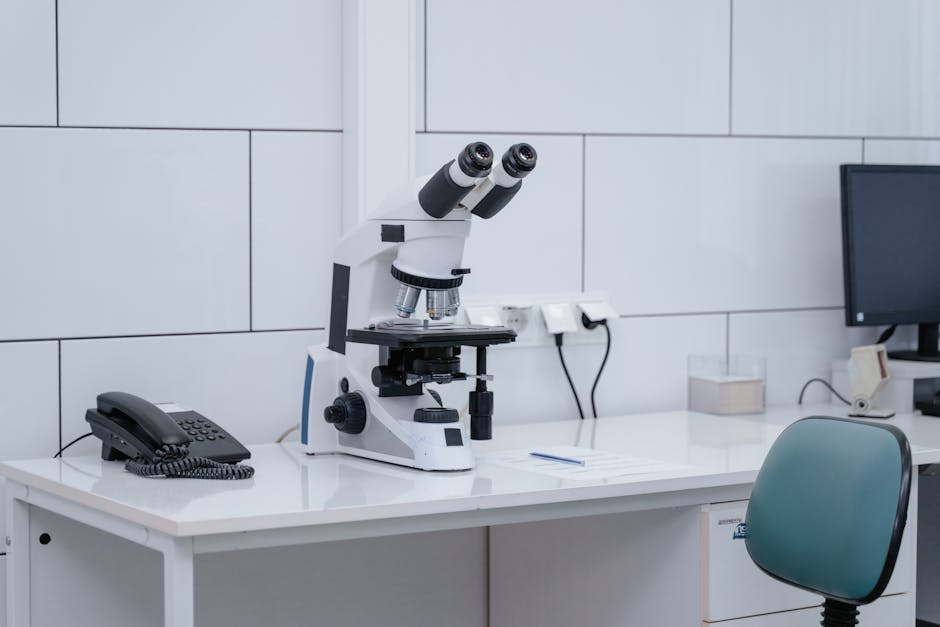 pexels photo 9574407 9574407 A well-equipped lab featuring a microscope on a contemporary desk setup.